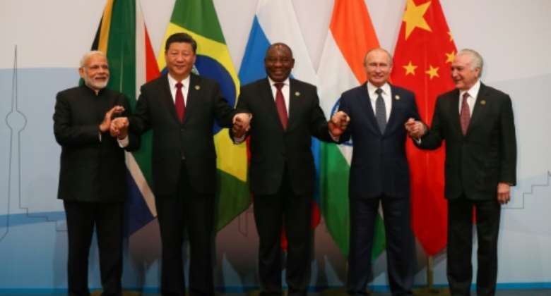 Arm in arm: Indian Prime Minister Narendra Modi, Chinese President Xi Jinping, South African President Cyril Ramaphosa, Russian President Vladimir Putin and President Michel Temer of Brazil.  By MIKE HUTCHINGS POOLAFP