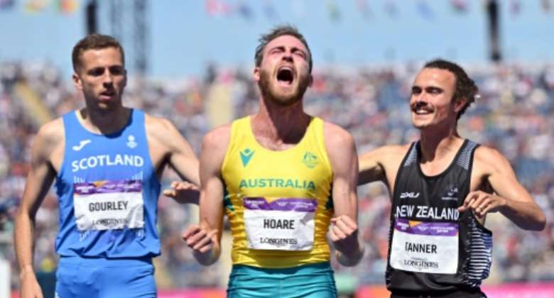 Australia's Oliver Hoare centre celebrates victory in the final of the men's 1500m at the Commonwealth Games.  By Glyn KIRK AFP