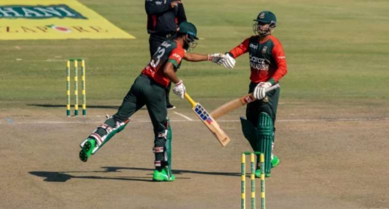Bangladesh opening batsmen Mohammad Naim L and Soumya Sarkar R fist bump during a 102-run first-wicket stand in a Twenty20 international against Zimbabwe in Harare on Thursday.  By Jekesai NJIKIZANA AFP