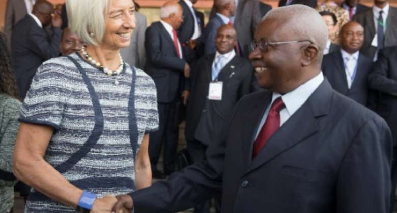 Before the storm: The then head of the IMF, Christine Lagarde, is greeted by Guebuza in Maputo in May 2014.  By STEPHEN JAFFE IMFAFPFile