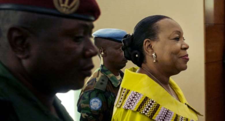 Central African Republic transitional President Catherine Samba Panza R arrives at a hotel in Bangui on December 9, 2015, as presidential candidates gather to sign a code of conduct agreed for elections to be held on December 27.  By Marco Longari AFP