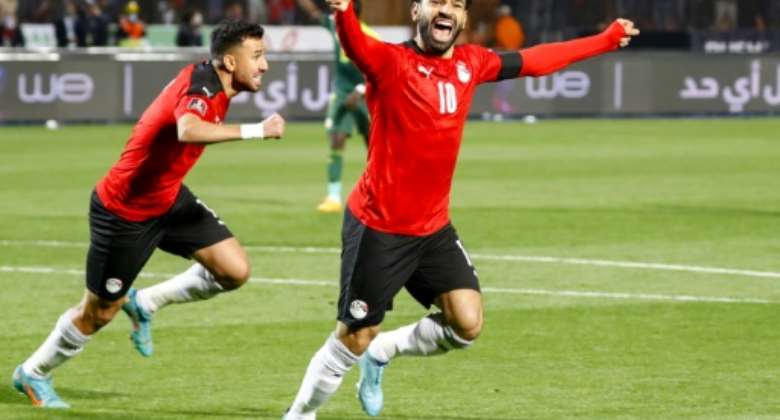 Captain Mohamed Salah R and midfielder Mahmoud 'Trezeguet' Hassan L celebrate after Egyypt took an early lead in a World Cup play-off against Senegal in Cairo on March 25, 2022..  By Khaled DESOUKI AFP