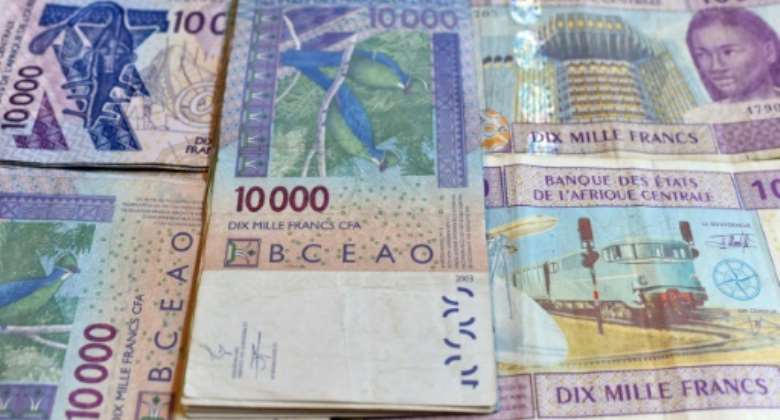 CFA banknotes issued by the  Central Bank of West African States -- but the currency's pegging to the euro is controversial and  politically sensitive, prompting moves to introduce a new currency, the eco.  By ISSOUF SANOGO (AFP/File)