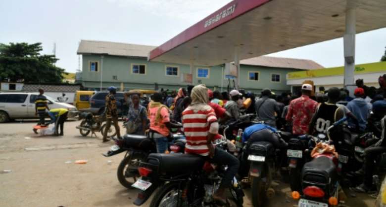 Consumers rushed to buy petrol on Tuesday after newly-elected President Bola Tinubu announced the end to Nigeria's costly fuel subsidies.  By PIUS UTOMI EKPEI AFP
