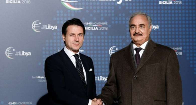 Conte (L) greeted Haftar upon his arrival in Palermo for the conference.  By Filippo MONTEFORTE (AFP)