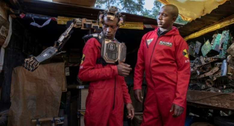 David Gathu, left, and Moses Kiuna are self-taught Kenyan innovators who have built a bio-robotic prosthetic arm out of electronic scrap.  By Tony KARUMBA AFP