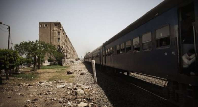 A train passes through the Egyptian Delta region, 50 kms north of the capital Cairo, in May.  By Marco Longari AFPFile