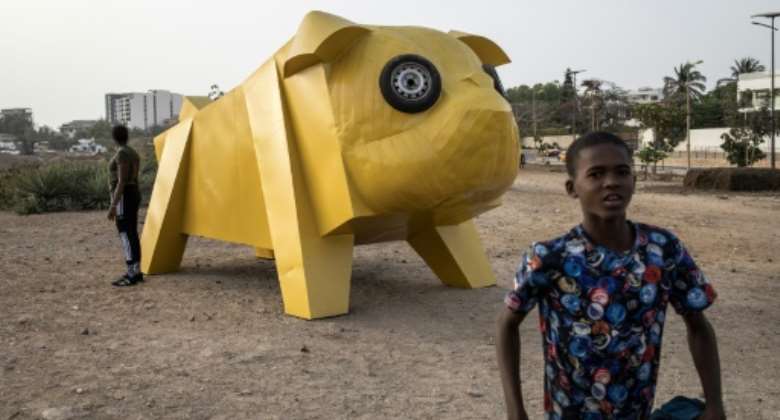 Egyptian artist Khaled Zakis massive dog sculpture is a popular spot for photos.  By JOHN WESSELS AFP