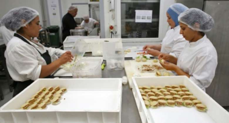 Employees of the Tunisian patisserie chain Gourmandise.  By - AFP