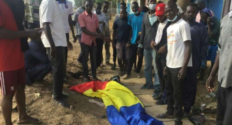Fatal protest: A body covered by a Chadian flag after the October 20 unrest.  By - AFPFile