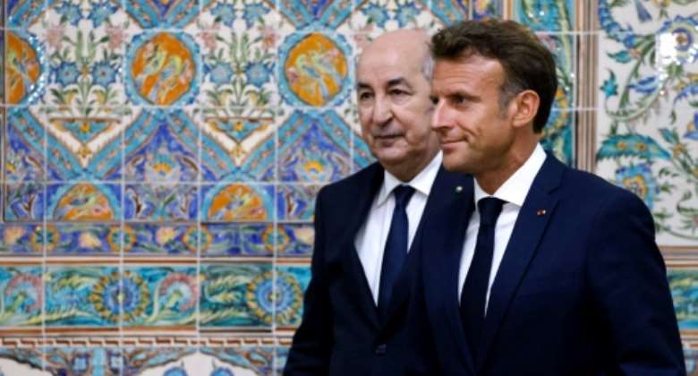French President Emmanuel Macron R and Algeria's President Abdelmadjid Tebboune L leave at the end of a joint press conference at the presidential palace in Algiers on August 25, 2022.  By Ludovic MARIN AFP