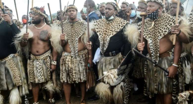 Future king: Prince Misuzulu, second right, arrives with Zulu warriors for the memorial service in May 2021 of his mother, Queen Shiyiwe Mantfombi Dlamini.  By - AFP