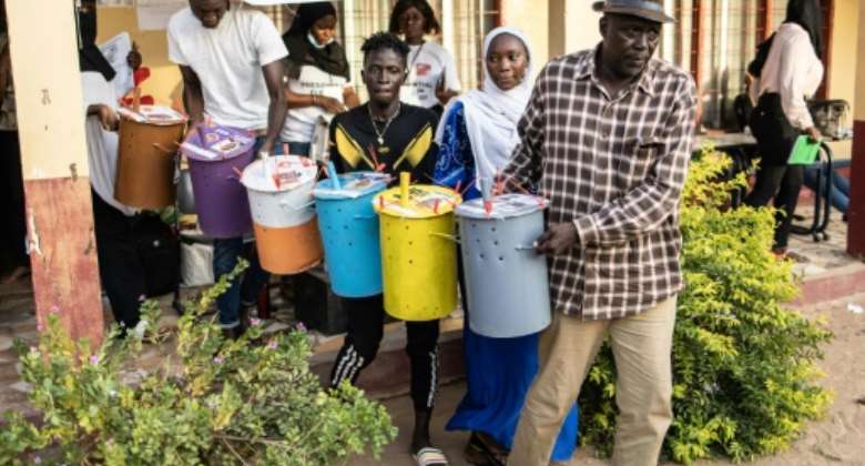 Gambians voted by dropping marbles into coloured tubs, due to high levels of illiteracy.  By JOHN WESSELS AFPFile