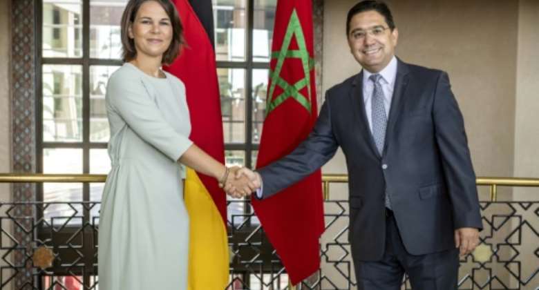German Foreign Minister Annalena Baerbock shakes hands with Moroccan counterpart Nasser Bourita on a visit to Rabat.  By FADEL SENNA AFP