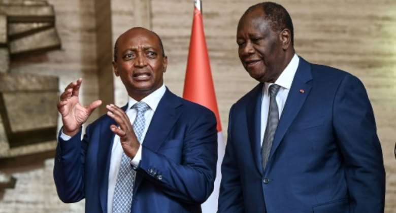 Ivorian President Alassane Ouattara R and CAF president Patrice Motsepe L at the presidential palace in Abidjan on Monday.  By Sia KAMBOU AFP