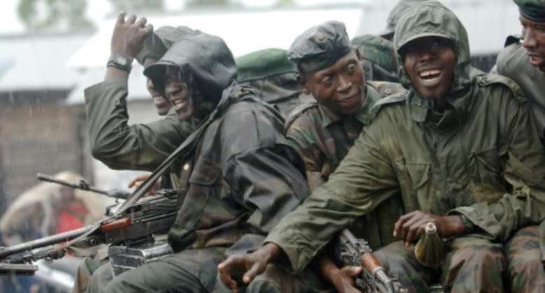 January 2009: CNDP rebels pass through a government checkpoint near Goma on their first step to joining the ranks of the armed forces.  By LIONEL HEALING AFP