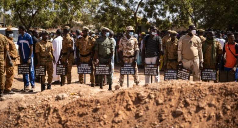 Jihadist toll: Military officials at Gounghin cemetery in Ouagadougou last November, bearing signs with the names of soldiers killed in an attack the week before.  By OLYMPIA DE MAISMONT AFP