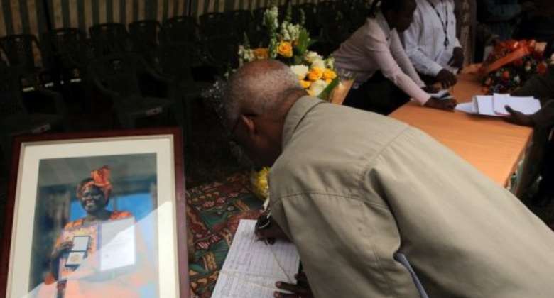 A Kenyan signs a condolence book for Wangari Maathai, who died of cancer on Sunday.  By Simon Maina AFP