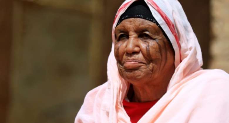 Kholoud Massaed of the Hadaria tribe in Sudan, bears blade scars on her face.  By ASHRAF SHAZLY AFP