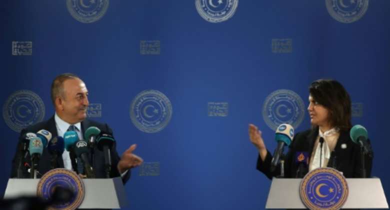 Libyan Foreign Minister Najla al-Mangoush and Turkish Foreign Minister Mevlut Cavusoglu speak to reporters after s signing a maritime gas deal.  By Mahmud Turkia AFP