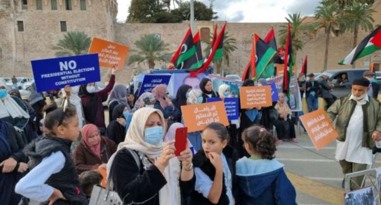 Libyans protest in the capital's Martyrs' Square against presidential runs by eastern strongman Khalifa Haftar and a son of slain dictator Moamer Kadhafi.  By Mahmud Turkia (AFP)