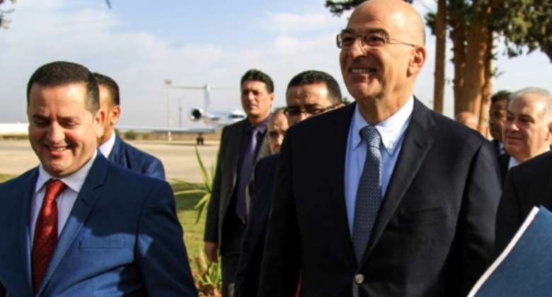 Libya's parallel eastern government foreign minister Abdulhadi Lahweej met Greek Foreign Minister Nikos Dendias in Benghazi on Sunday.  By Abdullah DOMA AFP