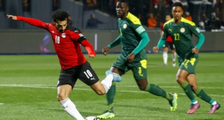 Liverpool star Mohamed Salah L scores for Egypt against Senegal in a World Cup play-off in Cairo on March 25, 2022..  By Khaled DESOUKI AFP