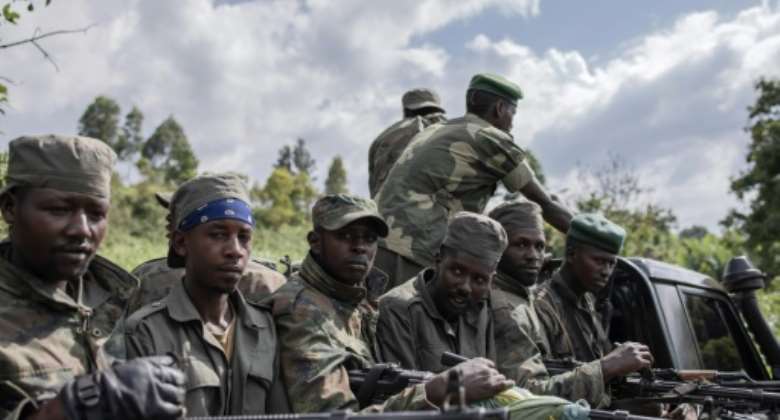 M23 rebels attending ceremonies at Rumangabo on January 6 when they handed back an army base they had seized.  By Guerchom Ndebo AFP