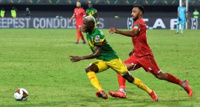 Mali winger Moussa Djenepo L is pursued by Equatorial Guinea captain and defender Carlos Akapo during an Africa Cup of Nations last-16 match in Limbe on Wednesday.  By Issouf SANOGO AFP