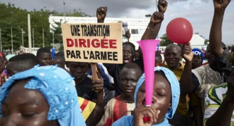 Malians rally in support of the junta several weeks after the 2020 coup. The sign reads: 'A transition led by the army'.  By MICHELE CATTANI AFPFile