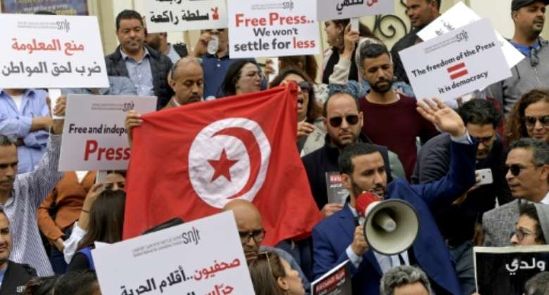 Mohamed Yassine Jelassi R, president of the National Syndicate of Tunisian Journalists SNJT, speaks through a megaphone during a protest demanding press freedom in Tunis.  By FETHI BELAID AFP