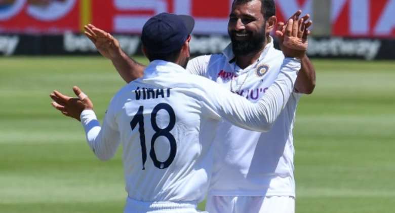 Mohammed Shami right celebrates with Indian captain Virat Kohli after the dismissal of South African batsman Kyle Verreynne on Wednesday.  By RODGER BOSCH AFP