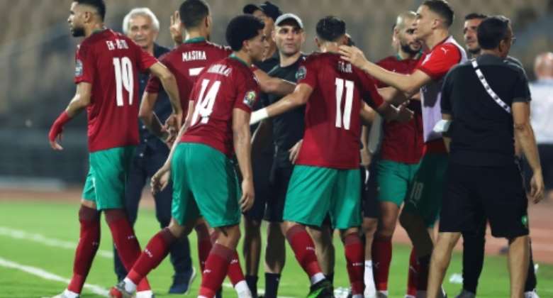 Morocco players celebrate after Zakaria Aboukhlal C scored their second goal against the Comoros.  By Kenzo Tribouillard AFP