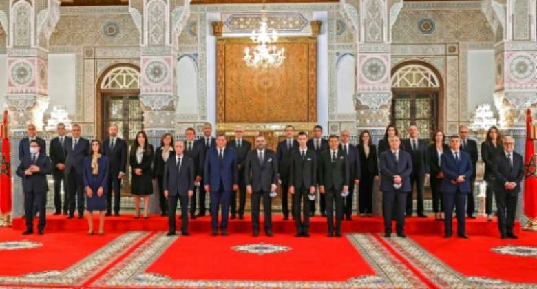 Morocco's King Mohammed VI, who retains wide powers despite ceding some prerogatives a decade ago, poses for a group photograph with members of his newly named government.  By - Moroccan Royal PalaceAFP