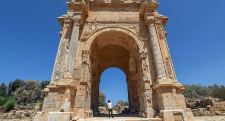 One of the few visitors to the ancient Roman city of Leptis Magna in Libya looks at the Arch of Septimius Severus.  By Mahmud TURKIA (AFP)