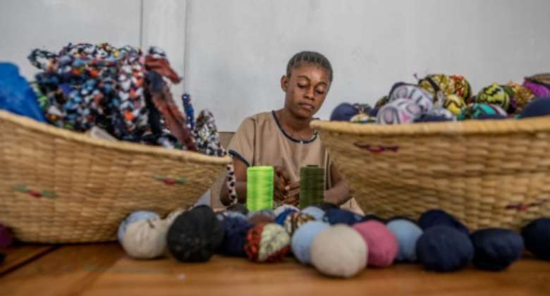 Out of piles of fabric all manner of objects take shape -- from placemats and rugs to earrings.  By Yanick Folly AFP