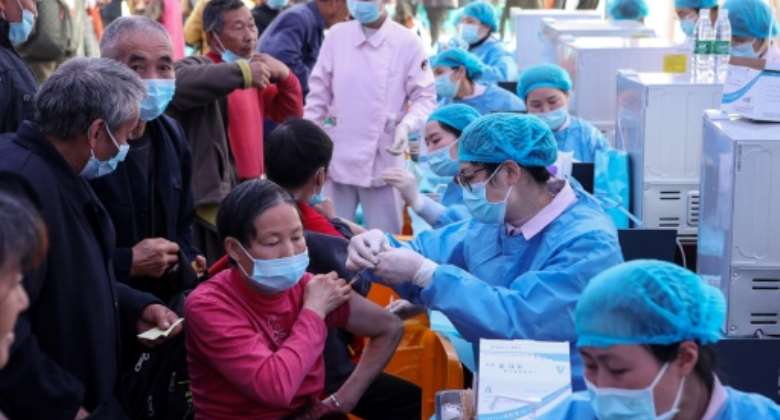 People receive Covid-19 vaccines in China's southwestern city of Chongqing.  By STR (AFP/File)