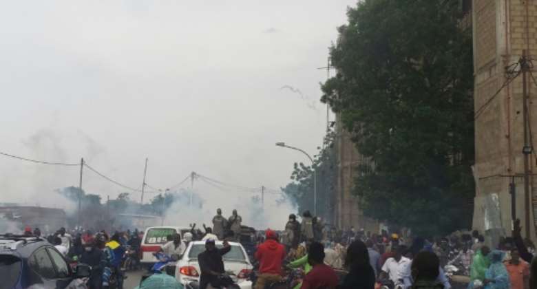 Police fired tear gas to disperse a large crowd surrounding opposition leader Succes Masra's car.  By - AFP