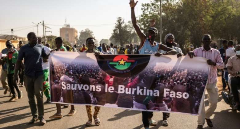 Protesters in Ouagadougou on Saturday hold up a banner reading 'Save Burkina Faso'.  By OLYMPIA DE MAISMONT (AFP)
