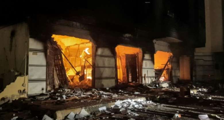 Protesters set a blaze in Libya's Tobruk-based parliament while demonstrating against deteriorating living conditions and political deadlock.  By - AFP