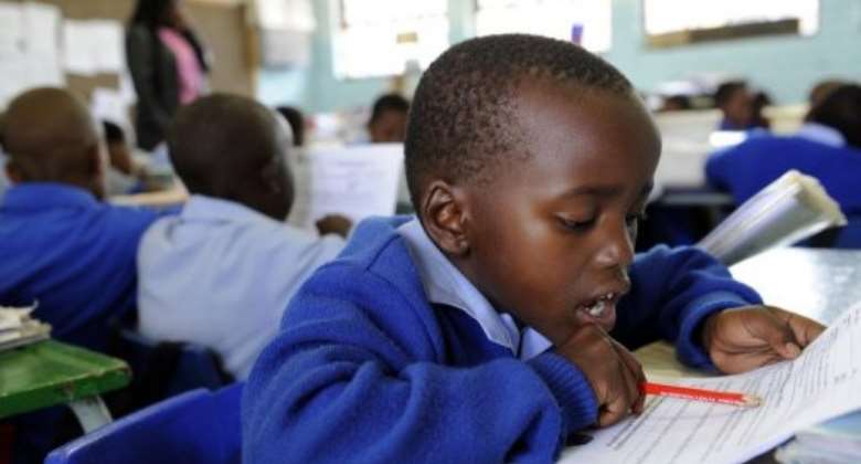 A South African boy studies in school in Soweto on November 3, 2009.  By Stephane de Sakutin AFPFile