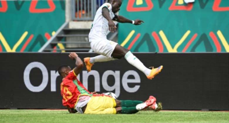 Senegal captain and forward Sadio Mane (R) evades a tackle by Guinea defender Issiaga Sylla during an Africa Cup of Nations Group B match in Bafoussam on Friday..  By Pius Utomi EKPEI (AFP)
