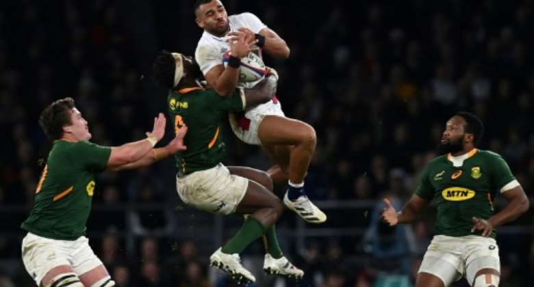 South Africa captain Siya Kolisi 2L contests possession with England wing Joe Marchant 2R in a November 2021 Test which England won 27-26 in London.  By Glyn KIRK AFPFile