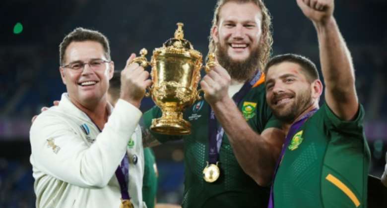 South Africa head coach Rassie Erasmus L celebrates with lock RG Snyman C and full-back Willie le Roux R after winning the 2019 Rugby World Cup final against England in Japan..  By Odd ANDERSEN AFP