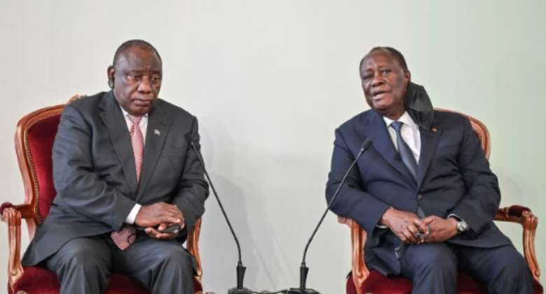 South Africa's President Cyril Ramaphosa left deplores 'unfair' travel bans imposed on his country, after meeting his Ivorian counterpart Alassane Ouattara right.  By Sia KAMBOU AFP