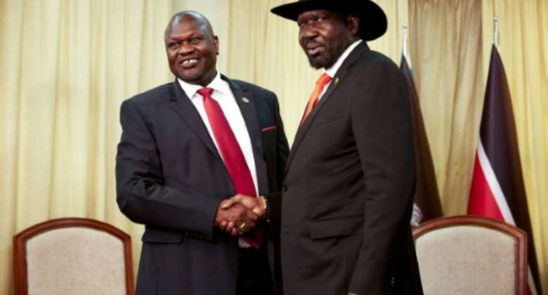 South Sudan's former rebel leader Riek Machar left meets with South Sudan's President Salva Kiir in October 2019.  By Alex McBride AFPFile