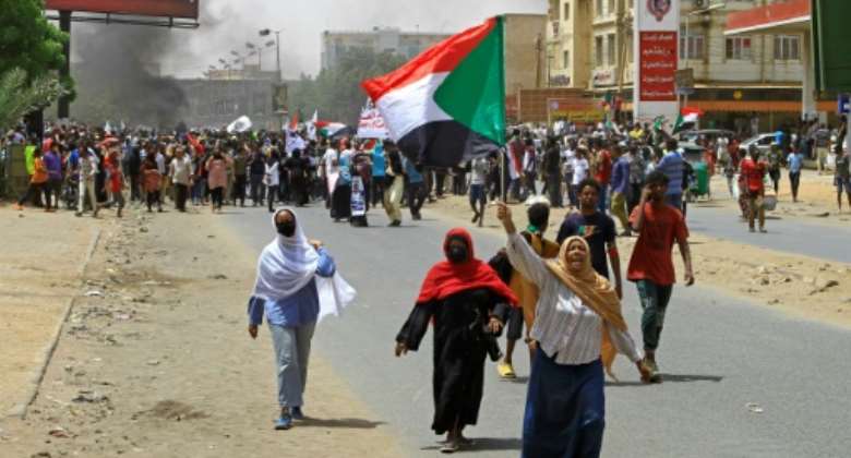 Sudanese anti-coup protesters march during a demonstration in Omdurman, the capital Khartoum's twin city, on June 30.  By - AFP