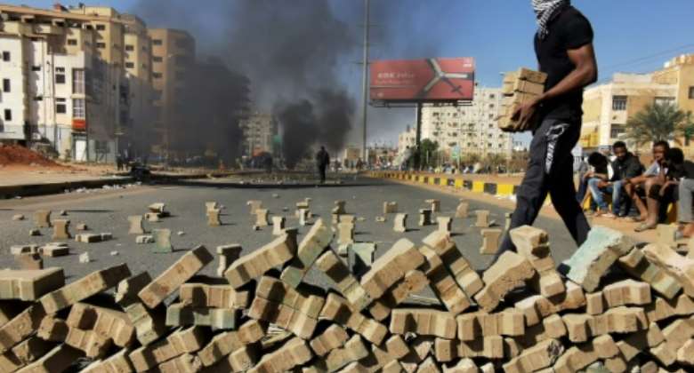 Sudanese protesters block a street in Khartoum in anti-coup protests, seen here on January 20.  By - AFP