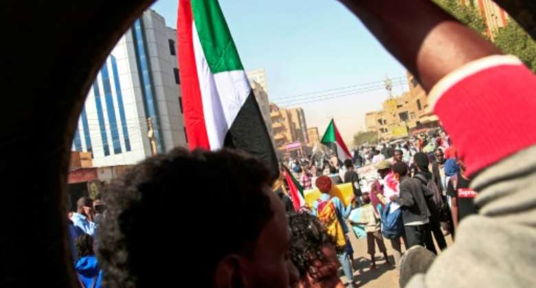 Sudanese rally against last year's military coup and demand civilian rule in Khartoum braving tear gas from security forces.  By - AFP