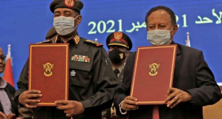 Sudan's top general Abdel Fattah al-Burhan, on the left, and Prime Minister Abdalla Hamdok during the deal-signing ceremony to restore the transition to civilian rule.  By - (AFP)